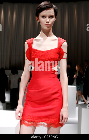 Versus Milan Ready to Wear Spring Summer Short red dress with lace bodice, cut out detail and lace trim Stock Photo