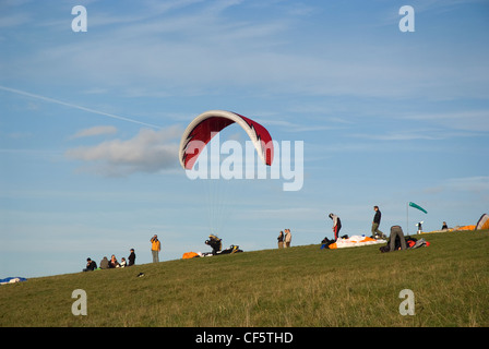 Paragliders preparing to fly on Devil's Dyke. Stock Photo