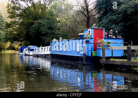 A houseboat, narrow boat and cabin cruisers moored at Pyrford Lock on the Wey Navigation Canal. Stock Photo