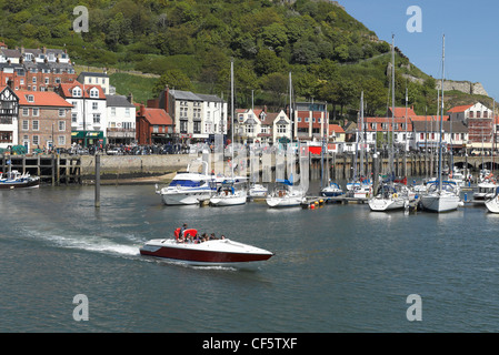 Tourists in a speedboat leaving Scarborough Harbour. Stock Photo