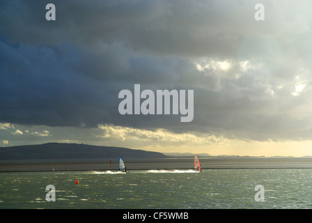 Windsurfing on Marine Lake at West Kirby on the Wirral Peninsula. Stock Photo