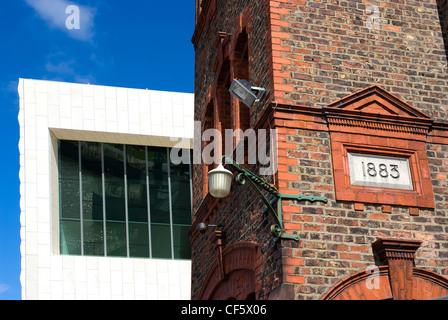 An old wharf building in front of the new Museum of Liverpool on Mann Island. Stock Photo