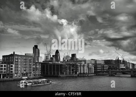 View across the River Thames towards iconic London landmarks, 'the Gherkin and Tower 42, (formerly known as the NatWest Tower), Stock Photo