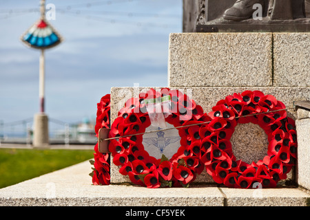 Poppy wreaths laid in remembrance at the foot of the war memorial on the seafront at Blackpool. Stock Photo