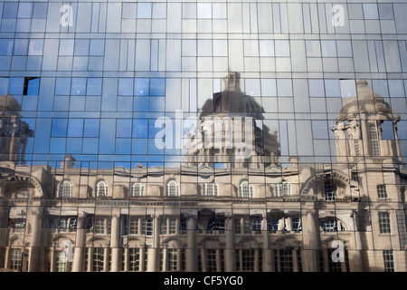 The Port of Liverpool Building reflected in the glass cladding of a modern new building. Stock Photo