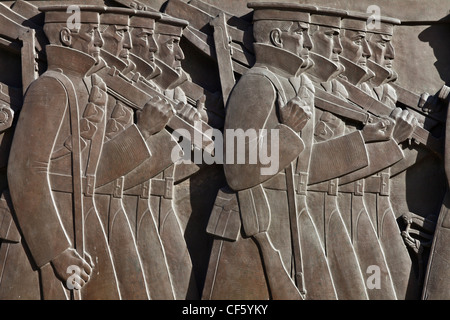 Sculpted bronze reliefs depicting an army on the move in a long march, on the Cenotaph in Liverpool. Stock Photo