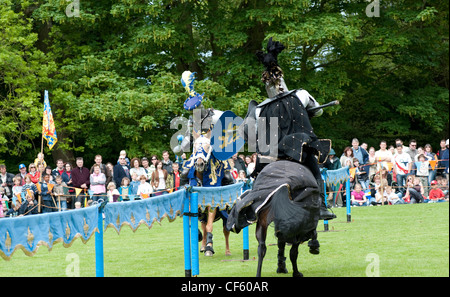 Two knights battle in a jousting tournament at Hedingham Castle. Stock Photo