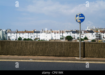 A street scene showing terraced housing and a One Way traffic sign In Brighton. Stock Photo