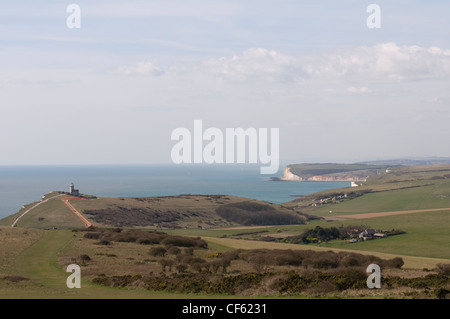 A view from Beachy Head looking west along the coast with the Belle Tout Lighthouse seen in the distance. Stock Photo