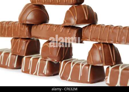 many chocolate appetizing candys with icing pyramid figure, isolated Stock Photo
