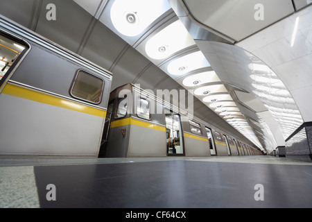 modern grey train on metro station with opened doors, granite floor, big lamps Stock Photo