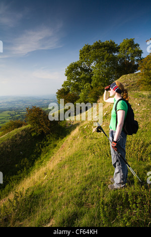 A young woman admiring the view from Castell Dinas on the Pengenffordd pass in the Brecon Beacons National Park. Stock Photo
