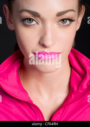 Beautiful woman wearing matching pink lipstick and jacket Stock Photo