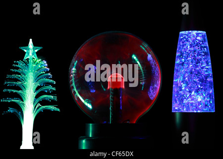Three souvenir lamps of different form: conifer,  round  red and cylindrical blue  on black background. Stock Photo