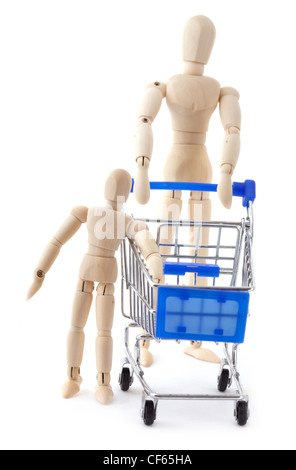Family shopping concept. Wooden dolls family go to the supermarket with metal shopping cart. Stock Photo
