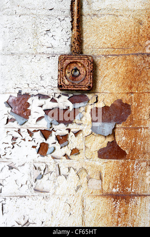 Decrepit wall light switch. The direction of the switch that means "on" varies by country, in the United States it is universal Stock Photo