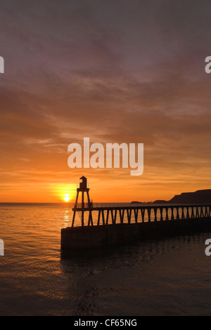 Whitby Harbour wall at sunset. Stock Photo