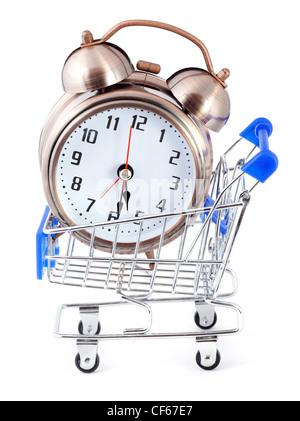 Old-styled alarm clock in small shopping cart. Stock Photo