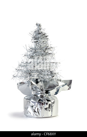Silver artificial Christmas tree made of tinsel grows from gift wrapping Stock Photo