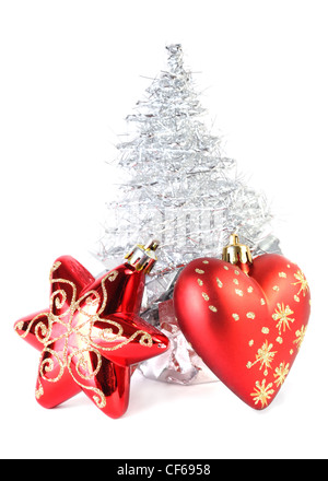 Red Christmas tree star heart near silver artificial Christmas tree made tinsel grows gift wrapping star heart in focus Stock Photo