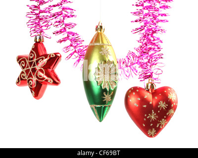 Various colorful christmas-tree decorations hanging on purple tinsel Stock Photo