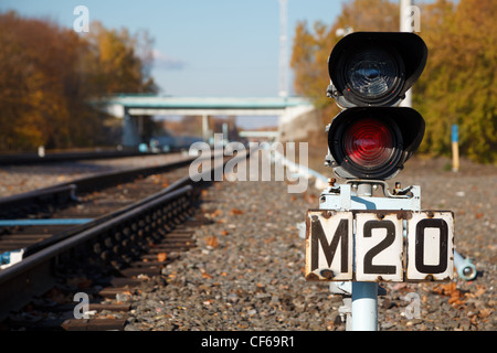 Traffic light shows red signal on railway. Railway station. Stock Photo