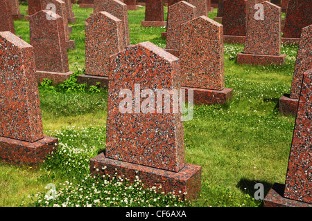 The obelisks of red granite standing in the green grass at the military memorial Stock Photo