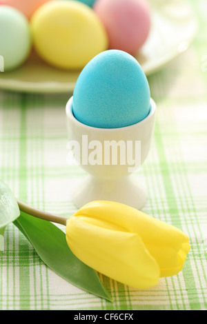 Easter eggs and tulip on table Stock Photo