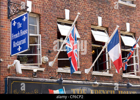 Union flags and a French tricolour flying outside the French House Restaurant in Dean Street, Soho. Stock Photo