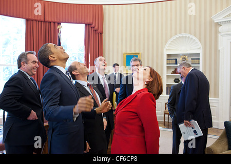 President Barack Obama, Prime Minister Julia Gillard of Australia, and members of the Australian and American delegations look up at the presidential seal in the Oval Office ceiling following their bilateral meeting March 7, 2011 in Washington, DC. Stock Photo