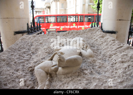 A sculpture of a new born baby in a block of concrete outside St Martin in the Fields near Trafalgar Square. The sculpture is by Stock Photo