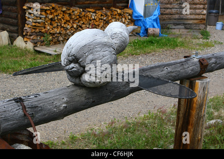 Wood carving of a mosquito on a hitching  post Stock Photo