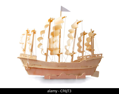 Homemade wooden ship with paper sails and a flag on a white background Stock Photo