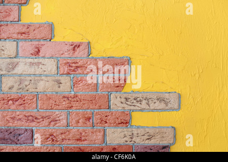 closeup of red brick wall and yellow plaster wall, bright interior Stock Photo