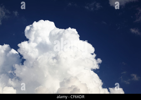 Big white massive cumulus clouds on background of pleasant blue color sky Stock Photo