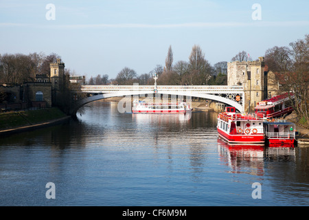 York City, Yorkshire, England river Ouse with tourist cruise boats moored and carrying tourists on trip Stock Photo