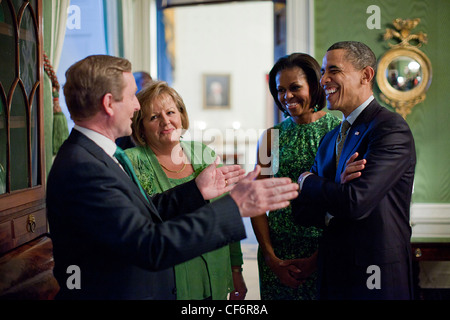 President Barack Obama and First Lady Michelle Obama talk with Irish Prime Minister Enda Kenny and his wife, Fionnuala Kenny in the Green Room of the White House before a St. Patrick's Day reception March 17, 2011 in Washington, DC. Stock Photo