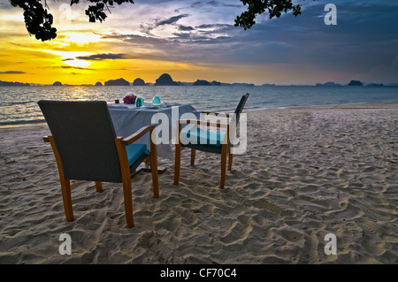 A romantic sunset dinner for two on the beaches of Krabi, Thailand. Stock Photo