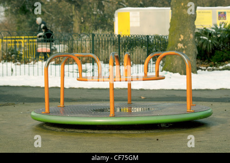 Traditional roundabout in children's playground at Finsbury Park, London UK Stock Photo