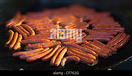 Frying sausages in large pan, France Stock Photo