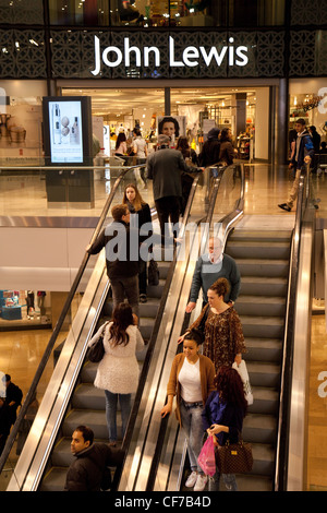 People going up the escalator to the John Lewis store, Westfield Shopping centre, Stratford London UK Stock Photo