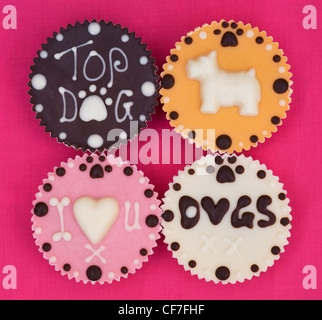 Four dog cupcakes in a square on a pink background. Stock Photo