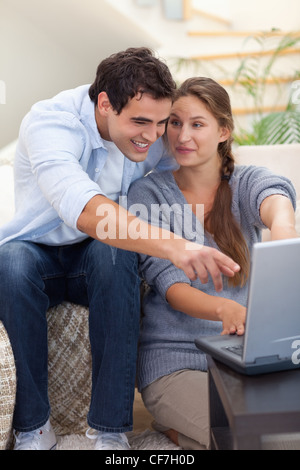 Portrait of a surprised couple using a laptop Stock Photo
