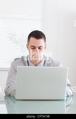 Close up of businessman working on his laptop Stock Photo