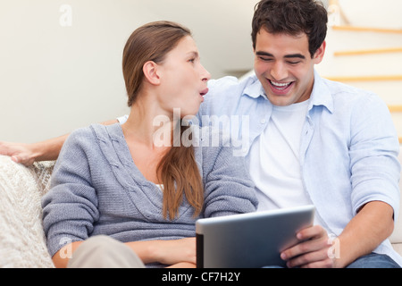 Laughing couple using a tablet computer Stock Photo