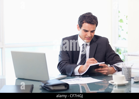 Businessman taking notes Stock Photo