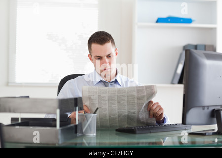 Businessman reading the newspaper Stock Photo