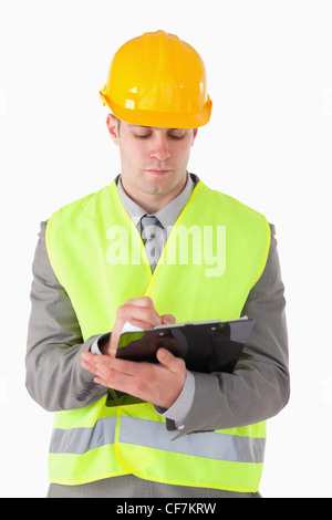 Portrait of a young builder taking notes Stock Photo