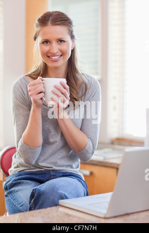 Smiling woman enjoying coffee Stock Photo