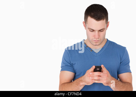Young man sending text messages Stock Photo